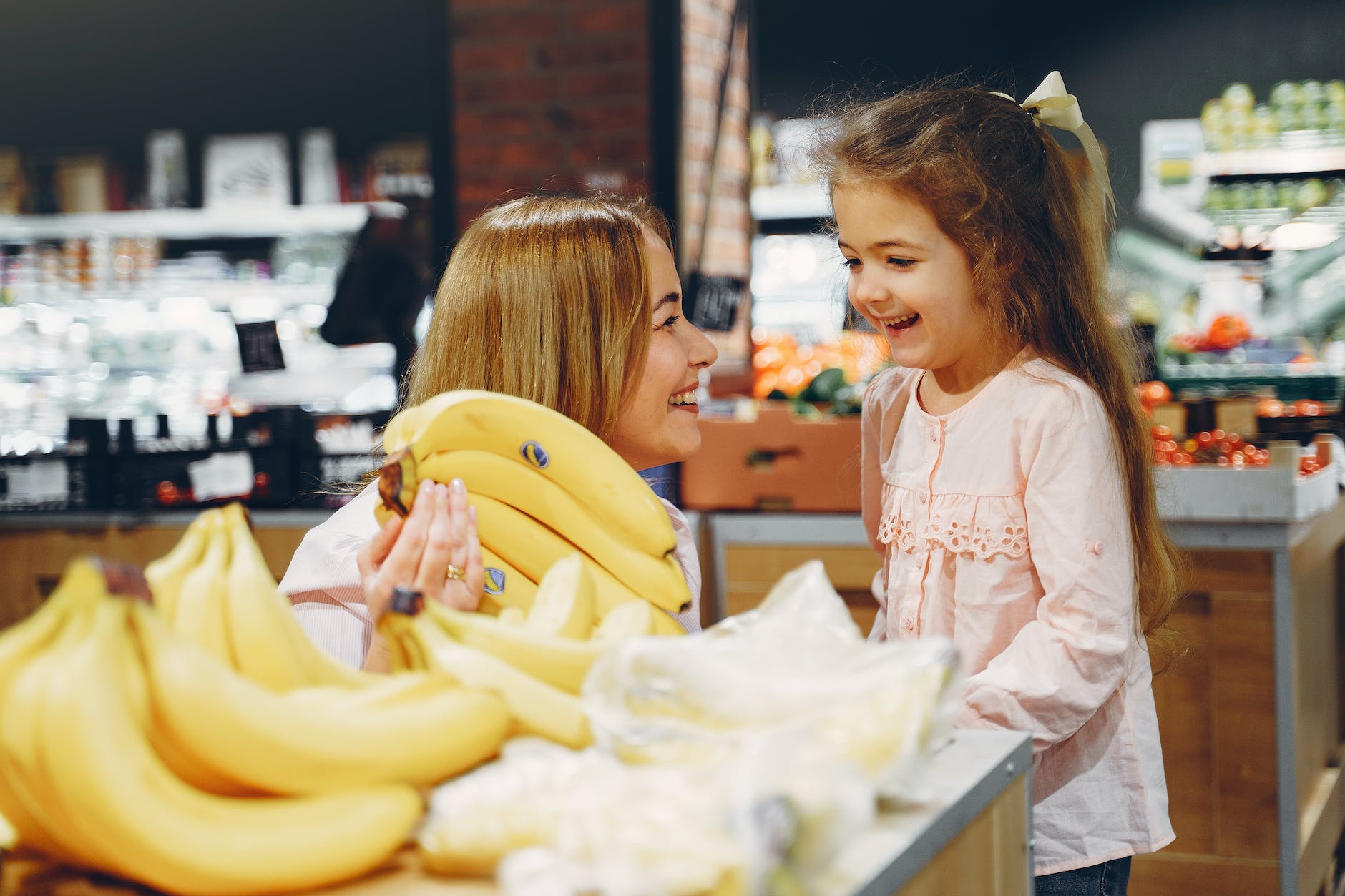 mother and daughter buying bananas